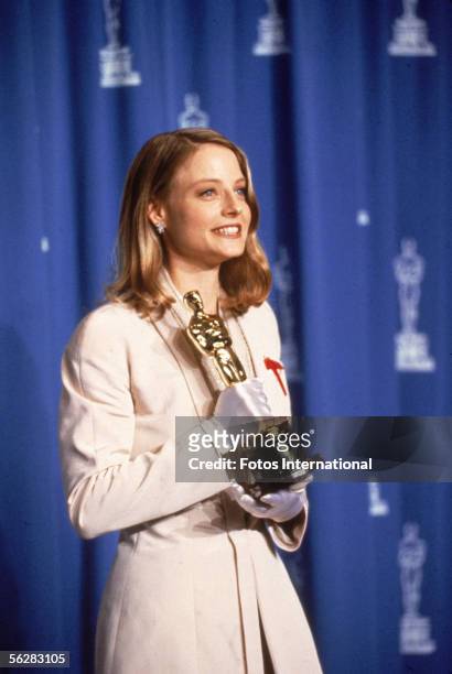 Dorothy Chandler Pavilion, Los Angeles, California American actress Jodie Foster poses backstage with her 'Oscar' award for Best Actress in a Leading...
