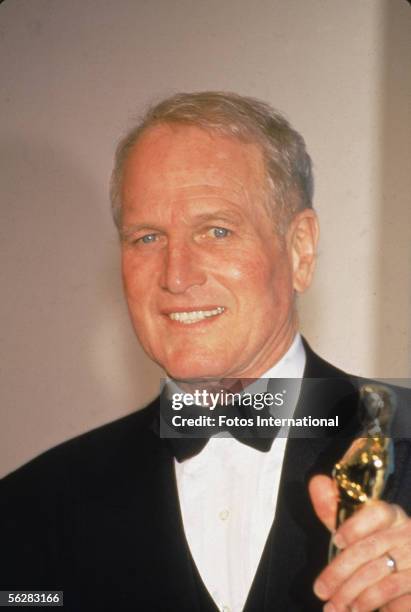 American actor Paul Newman poses backstage at the Dorothy Chandler Pavilion with his honorary 'Oscar,' the Jean Hersholt Humanitarian Award, for his...