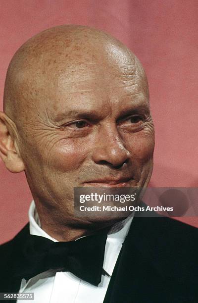 Actor Yul Brynner poses backstage after presenting "Best Foreign Language Film" award during the 46th Academy Awards at Dorothy Chandler Pavilion in...