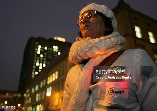Doctor carries a candle during a protests in front of the Charite Hospital on November 28, 2005 in Berlin, Germany. The doctors are on strike in...
