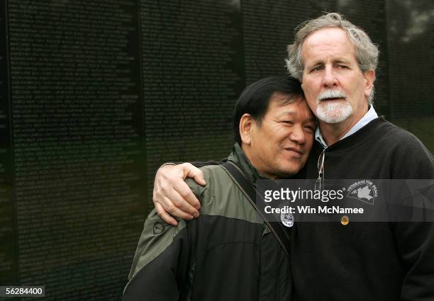 Former United States Marine Frank Corcoran , a member of Veterans for Peace, hugs Ho Sy Hai, a veteran of the North Vietnamese Army, during an event...