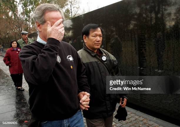 Former United States Marine Frank Corcoran wipes away tears as he tours the Vietnam War Memorial Wall with Ho Sy Hai , a veteran of the North...