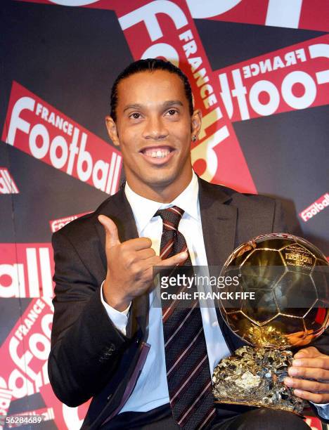 Brazilian Barcelona midfielder Ronaldinho poses with his trophy after being awarded as 50th Ballon d'Or , for best football player of the year, 28...