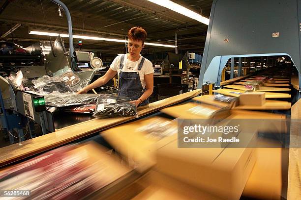Cindy Amsden places clothing orders on a conveyor belt in the L.L. Bean shipping center on "Cyber Monday," the online retail world's version of Black...
