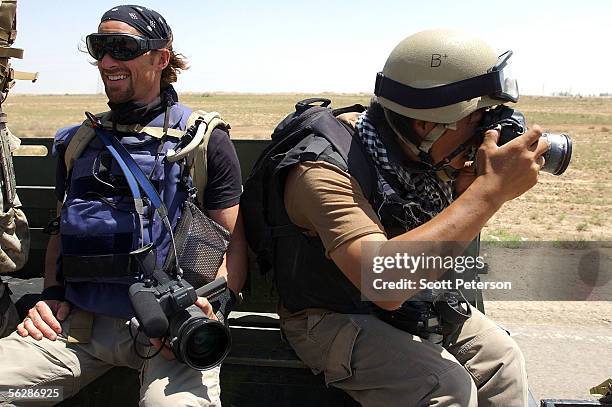 Embedded reporter Kevin Sites of NBC and photographer Sung Su Cho of Time magazine ride in the back of a U.S. Marines vehicle to a checkpoint May 1,...