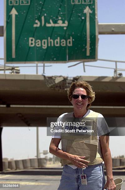 Embedded reporter Carol Rosenberg of the Miami Herald works at a checkpoint May 1, 2004 on the edge of Fallujah, Iraq. U.S. Marines launched a brief...