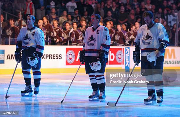 Brendan Morrison, Markus Naslund and Todd Bertuzzi of the Vancouver Canucks stand for the National Anthem before the game against the Los Angeles...