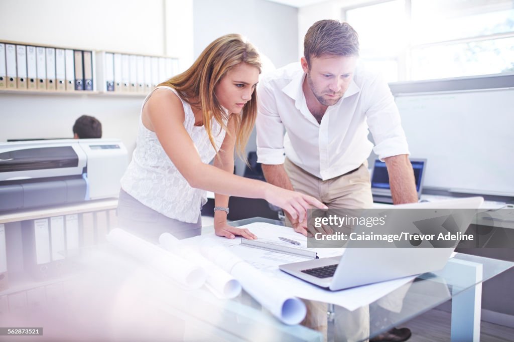 Architects using laptop in office