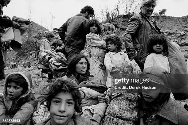 Family of Iraqi Kurds await food aid on a hillside in the barren no man's land near the the Turkish town of Isikveren. The Iraqi Kurdish community...