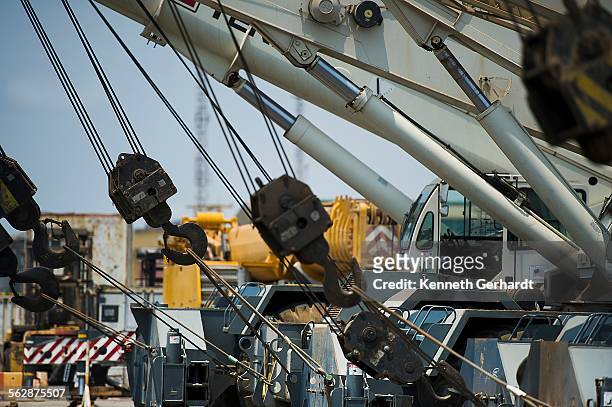 cranes lined up, angola, luanda bay - luanda bay stock pictures, royalty-free photos & images