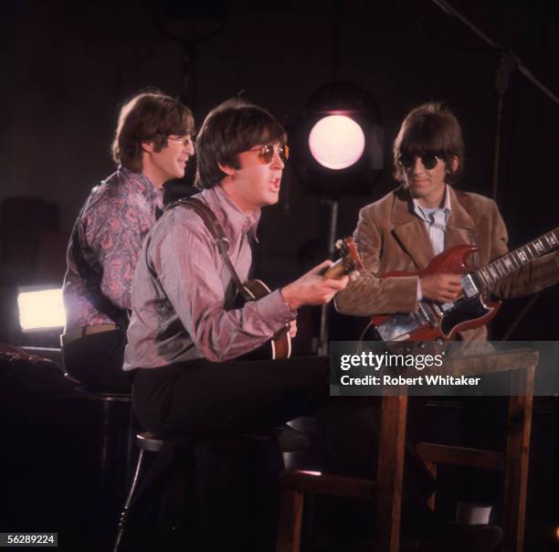 Beatles John Lennon, George Harrison and Paul McCartney playing their guitars during the Abbey Road session to record Paperback Writer and Rain,...