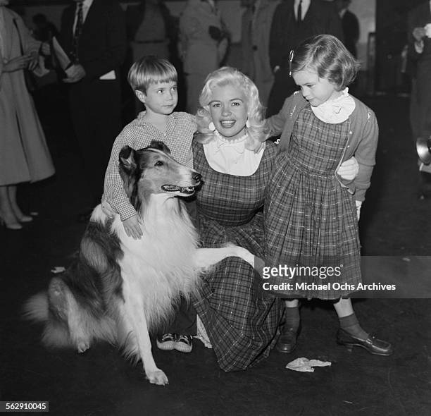 Actress Jayne Mansfield with her daughter Jayne Marie Mansfield pose with actor Jon Provost and Lassie during the Christmas Parade party in Los...