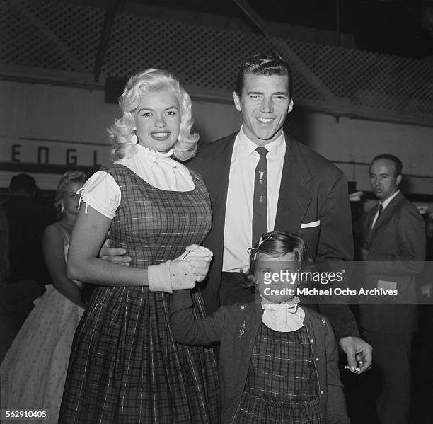 Actress Jayne Mansfield poses with her daughter Jayne Marie Mansfield and Mickey Hargitay during the Christmas Parade party in Los Angeles,California.