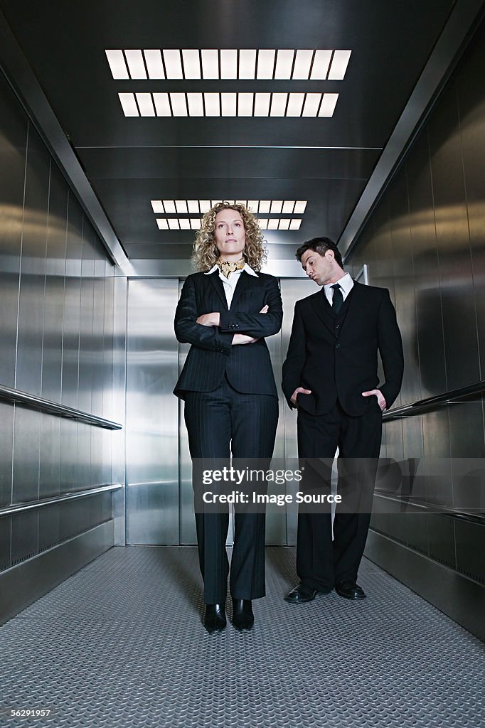 Businessman looking at businesswoman's behind