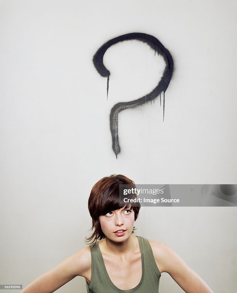 Woman in front of a question mark