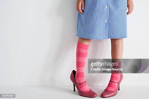 girl wearing woman's shoes - child high heels stock pictures, royalty-free photos & images