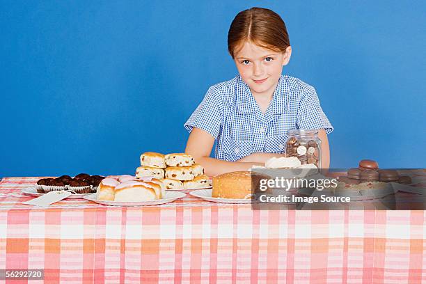 girl with cake stall - cake sale stock-fotos und bilder