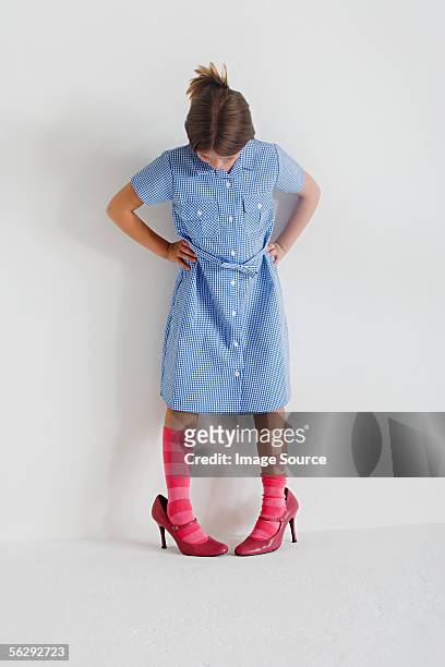 girl wearing woman's shoes - kid in big shoes stock pictures, royalty-free photos & images