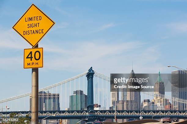 road sign and manhattan skyline - speed limit sign stock pictures, royalty-free photos & images