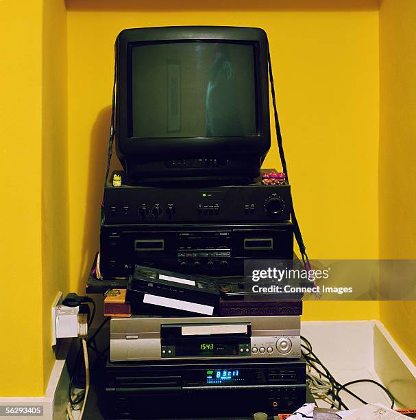 television on stack of electrical equipment - videocassette stock pictures, royalty-free photos & images