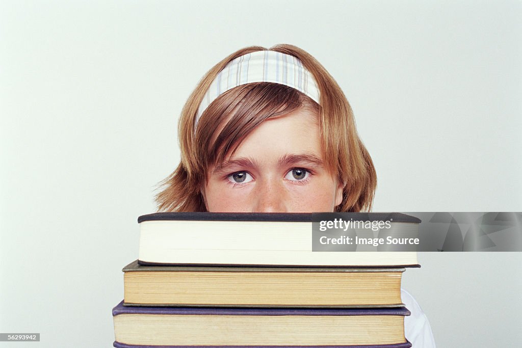 Girl holding a stack of books