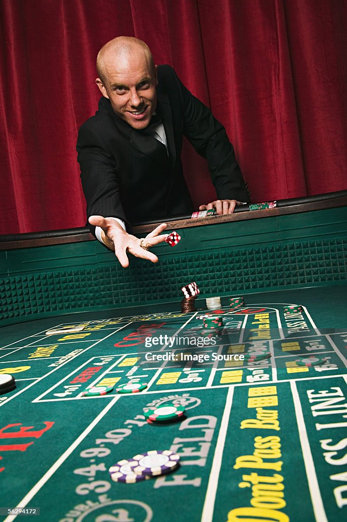 Man throwing dice at craps table