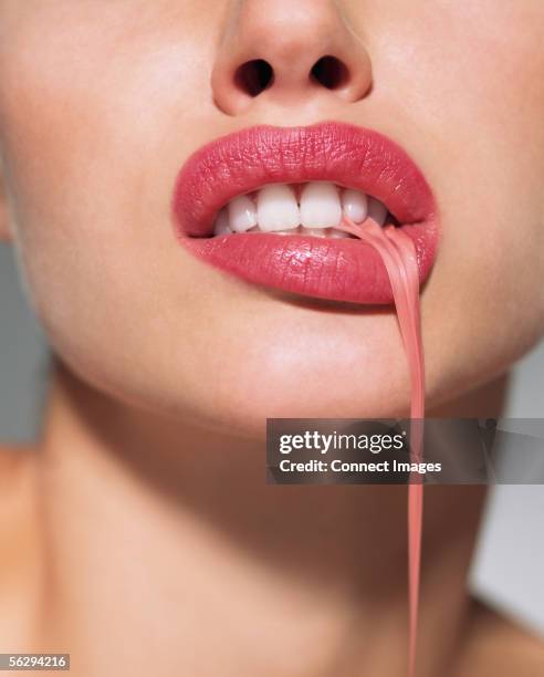 woman pulling gum with mouth - lips bubblegum stock pictures, royalty-free photos & images