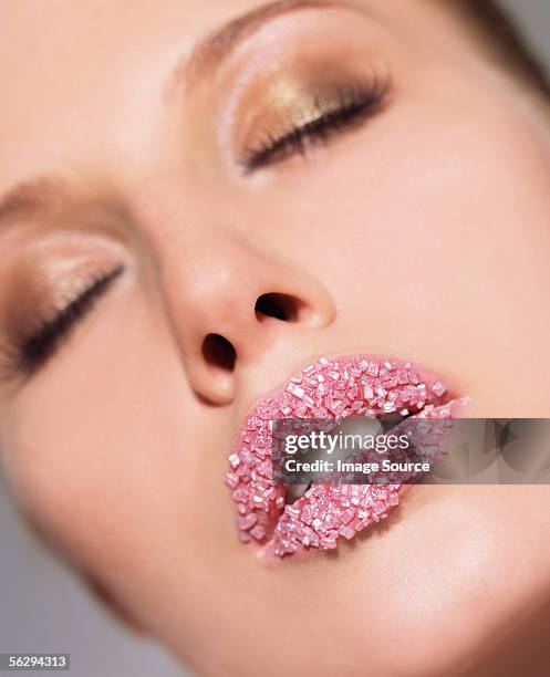 woman with pink sugar crystals on her lips - candy lips stock pictures, royalty-free photos & images
