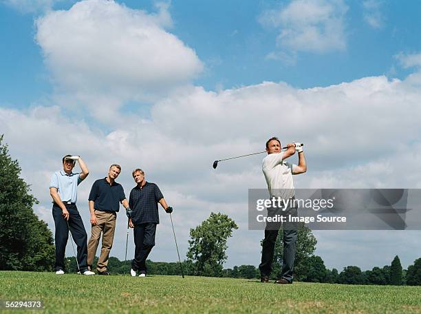 men playing golf - four people fotografías e imágenes de stock