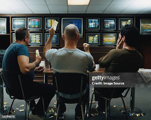 three men in a betting shop - sports betting stock-fotos und bilder