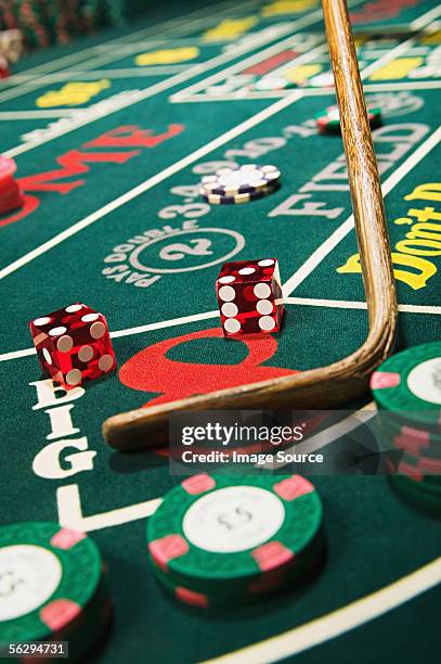 croupier stick clearing craps table - casino dice games stock pictures, royalty-free photos & images