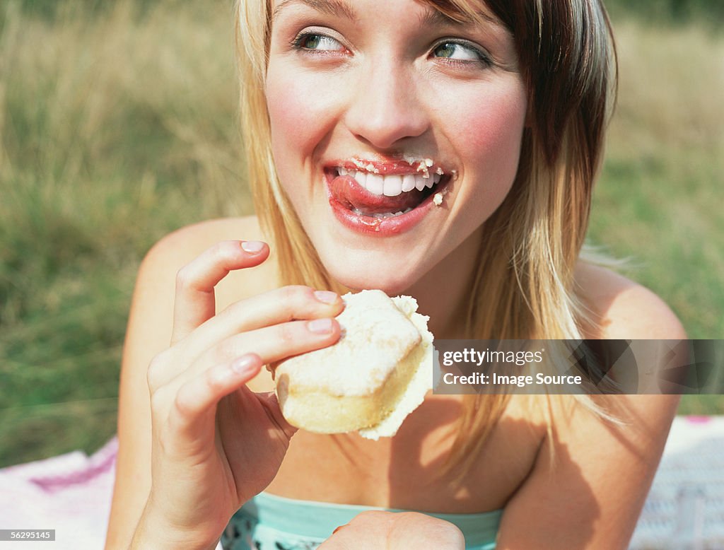 Frau isst einen Kuchen