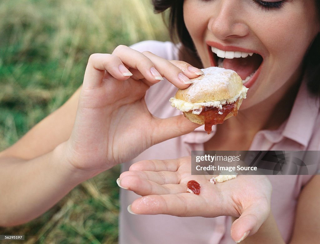 Woman eating a scone