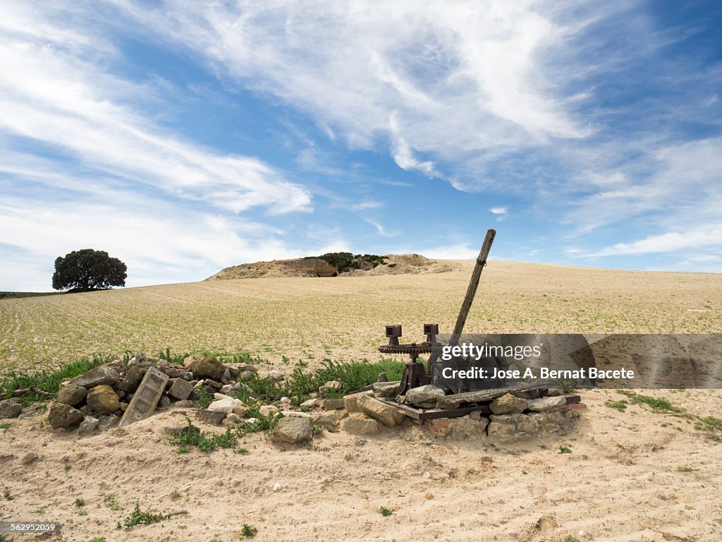 Ancient water well in a field of dry