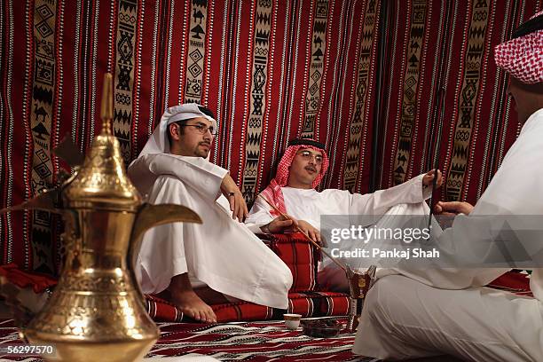 arab men on a tea session - majlis stock pictures, royalty-free photos & images