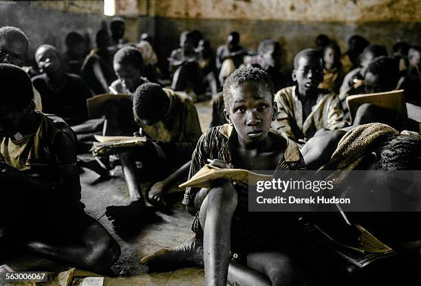 Children in a makeshift classroom in an abandoned Catholic mission where refugee children fled from the civil war in Sudan. Two hundred kilometres...