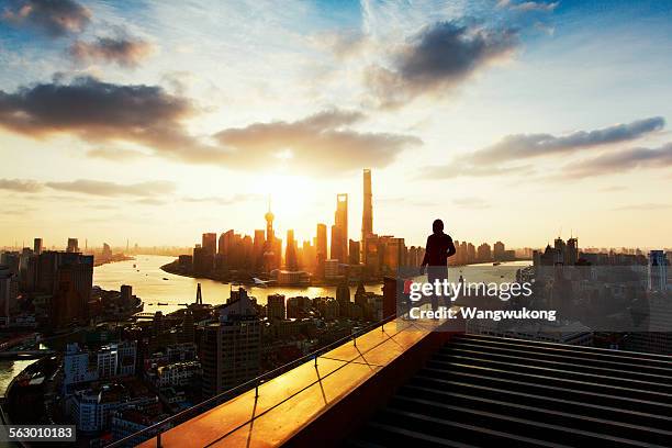 greete the sunrise - man on top of building stock pictures, royalty-free photos & images