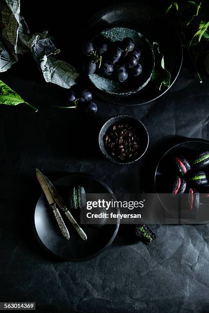 black macarons and grape - macaroon stock pictures, royalty-free photos & images