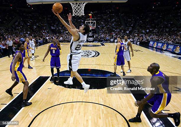 Guard Manu Ginobili of the San Antonio Spurs makes a reverse basket against Kobe Bryant of the Los Angeles Lakers on November 29, 2005 at the SBC...