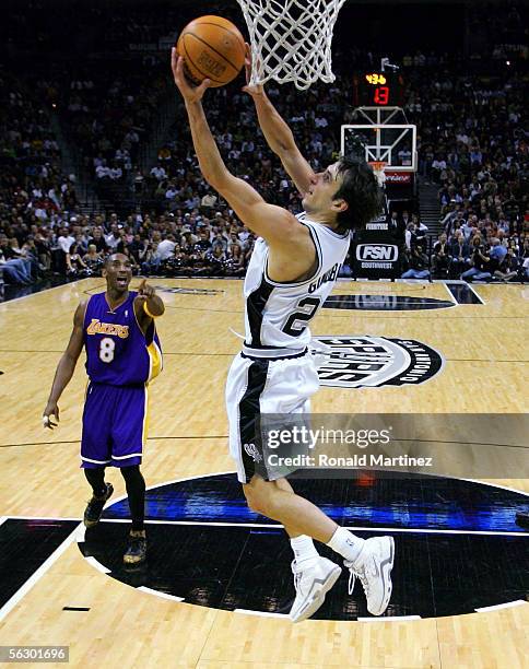 Guard Manu Ginobili of the San Antonio Spurs makes a reverse basket against Kobe Bryant of the Los Angeles Lakers on November 29, 2005 at the SBC...