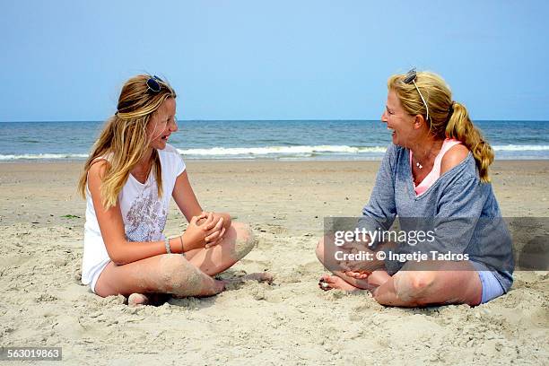 auntie and niece chatting on the beach in holland - vlieland stock pictures, royalty-free photos & images