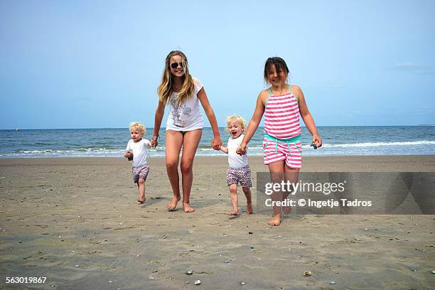 young kids running on the beach in holland - vlieland stock pictures, royalty-free photos & images