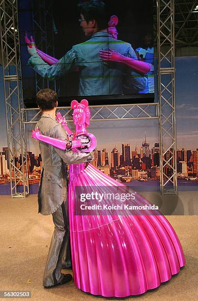 Partner Ballroom Dance Robots of robotic venture Nomura Unison dances with a man during 2005 International Robot Exhibition on November 30, 2005 in...