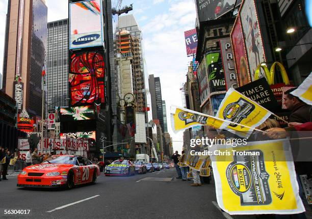 Cup Champion Tony Stewart in the Home Depot Chevrolet Car leads a procession of NASCAR drivers in the NASCAR Victory Lap through Times Square during...