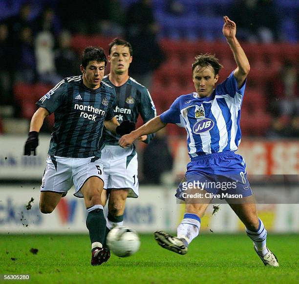 Belozoglu Emre of Newcastle United challenges Andreas Johansson of Wigan Athletic during the Carling Cup, fourth round match between Wigan Athletic...