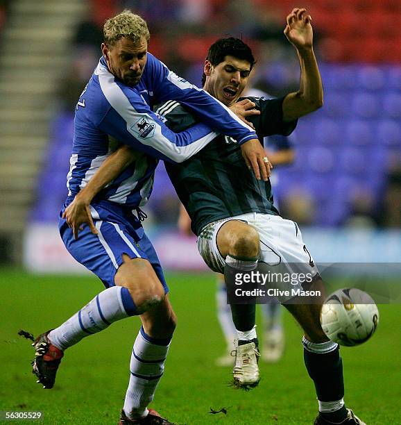 Albert Luque of Newcastle United challenges Stephane Henchoz of Wigan Athletic during the Carling Cup, fourth round match between Wigan Athletic and...