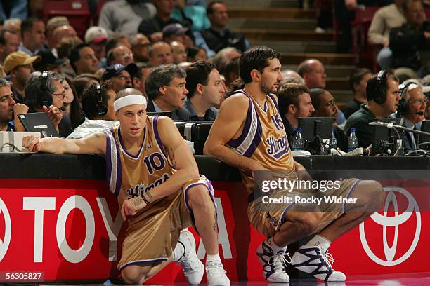 Mike Bibby and Peja Stojakovic of the Sacramento Kings sit next to the scorer's table as they wait to enter the game against the Utah Jazz November...