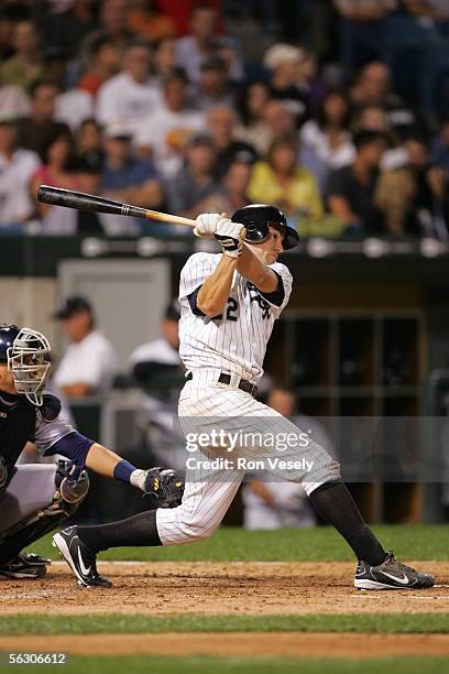 Scott Podsednik of the Chicago White Sox bats as Victor Martinez of the Cleveland Indians catches during the game at U.S. Cellular Field on September...