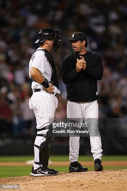 Manager Ozzie Guillen of the Chicago White Sox waits on the mound with catcher A.J. Pierzynski during the game against the Cleveland Indians at U.S....