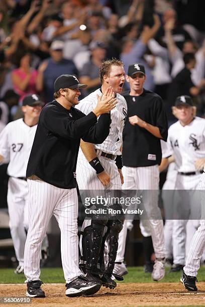 Mark Buehrle and A.J. Pierzynski of the Chicago White Sox celebrate a win against the Cleveland Indians at U.S. Cellular Field on September 20, 2005...